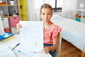 Image showing sad student girl with failed school test at home