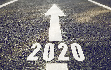 Image showing white road marking in form of 2020 year and arrow