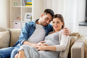 Image showing man hugging pregnant woman at home