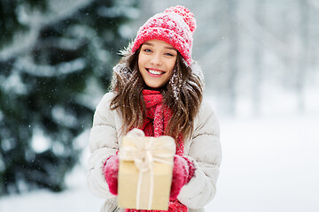 Image showing happy young woman with christmas gift in winter