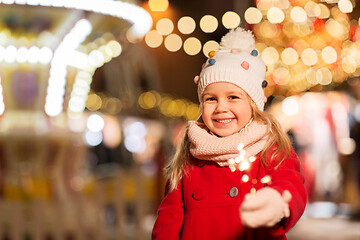 Image showing happy girl with sparkler at christmas market