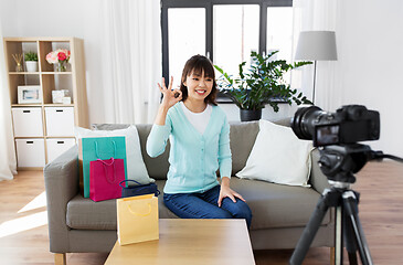 Image showing female blogger making video blog about shopping