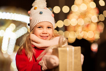 Image showing happy girl with gift box at christmas market