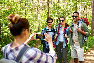 Image showing friends with backpacks being photographed on hike