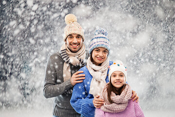 Image showing happy family in winter clothes on snow background