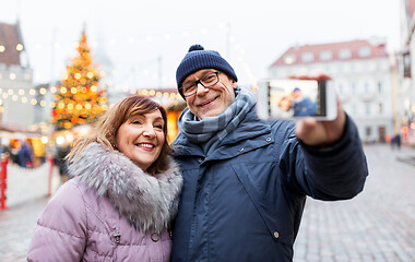 Image showing senior couple taking selfie at christmas market