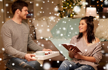 Image showing happy couple with book and food at home
