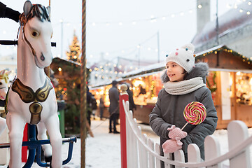 Image showing girl with lollipop at christmas market