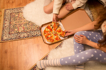 Image showing happy female friends eating pizza at home