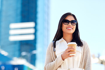 Image showing smiling woman with takeaway coffee cup in city