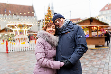 Image showing happy senior couple hugging at christmas market