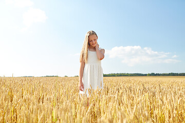 Image showing smiling young girl on cereal field in summer