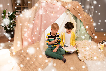 Image showing happy boys reading book in kids tent at home