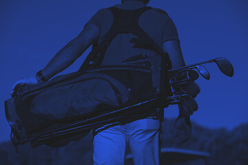 Image showing close up of golfers back while   walking and carrying golf  bag