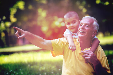 Image showing grandfather and child have fun  in park