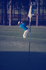 Image showing pro golfer hitting a sand bunker shot