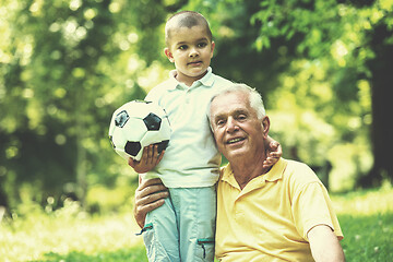 Image showing grandfather and child have fun  in park