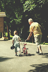 Image showing grandfather and child have fun  in park