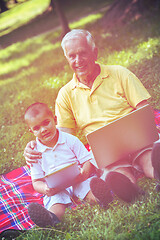 Image showing grandfather and child using laptop