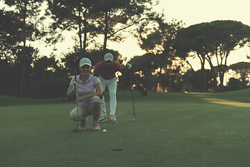 Image showing couple on golf course at sunset