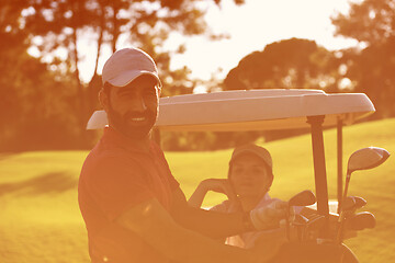 Image showing couple in buggy on golf course