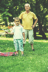 Image showing grandfather and child have fun  in park