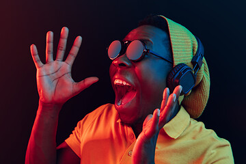 Image showing The young handsome hipster man listening music with headphones