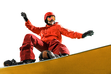 Image showing Portrait of young man in sportswear with snowboard isolated on a white background.