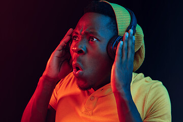 Image showing The young handsome hipster man listening music with headphones