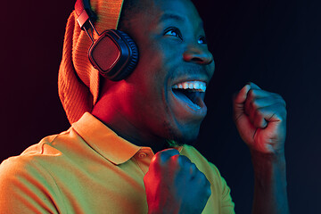 Image showing The young handsome hipster man listening music with headphones