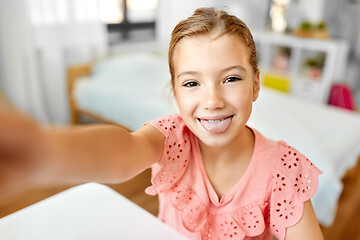 Image showing girl taking selfie and showing tongue at home