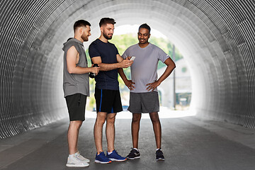 Image showing sporty men or friends with smartphone outdoors