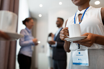 Image showing business people with conference badges and coffee