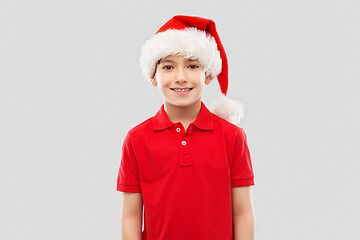 Image showing smiling boy in red t-shirt and santa helper hat