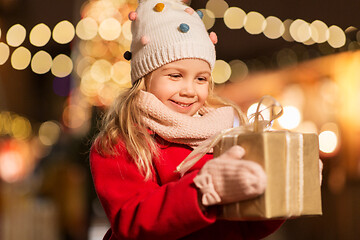 Image showing happy girl with gift box at christmas market