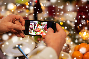 Image showing hands photographing food at christmas dinner