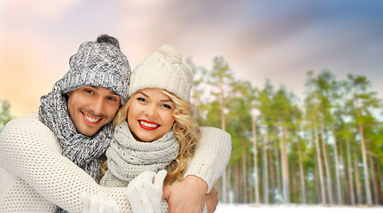 Image showing couple hugging over winter forest background