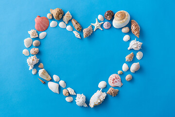 Image showing sea shells in shape of heart on blue background