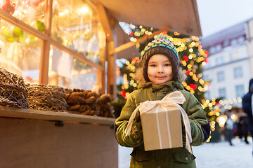 Image showing happy boy with gift box at christmas market