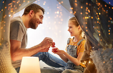 Image showing family playing tea party in kids tent at home