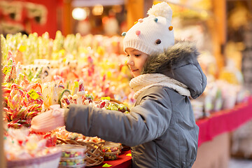 Image showing little girl choosing sweets at christmas market