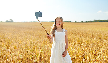Image showing happy young girl taking selfie by smartphone
