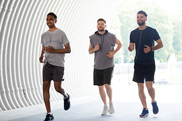 Image showing male friends with earphones running outdoors