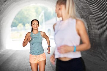 Image showing women or female friends with earphones running