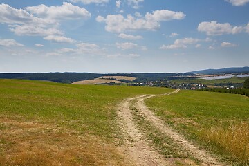 Image showing Country dirt road through farmlands