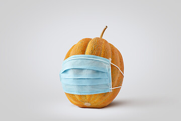 Image showing Fresh natural organic pumpkin or melon vegetable in a medical protective face mask.