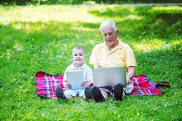 Image showing grandfather and child using laptop