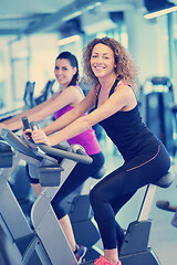 Image showing Group of people running on treadmills