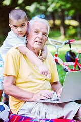 Image showing grandfather and child using laptop