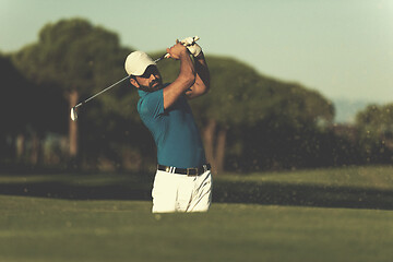 Image showing pro golfer hitting a sand bunker shot